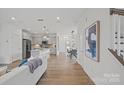 Open-concept living spaces flow seamlessly, showcasing a modern kitchen, dining area, and cozy living room at 10033 Guardian Dr # 265, Charlotte, NC 28273