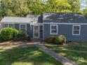 Charming single-story home with a well-manicured lawn and inviting front entrance at 1142 Mona Dr, Charlotte, NC 28206