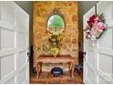 Welcoming foyer featuring a stone wall, elegant table, and decorative accents at 116 Pelham Ln, Fort Mill, SC 29715