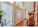 Bright foyer with large windows, hardwood floors, and decorative vase on a wood table at 116 Pelham Ln, Fort Mill, SC 29715