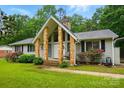 Inviting home exterior with stone accents, manicured lawn, and vibrant landscaping at 116 Pelham Ln, Fort Mill, SC 29715