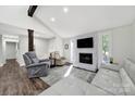 Bright living room with stone fireplace, hardwood floors, and a comfortable seating arrangement for relaxation at 11914 Rock Canyon Dr, Charlotte, NC 28226