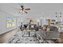 Bright living room featuring hardwood floors, neutral walls, stylish furniture, and modern ceiling fan at 130B Springway Dr, Kannapolis, NC 28081