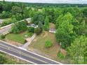 Aerial view of a residential property surrounded by lush greenery and a view of the road at 1317 Requa Rd, Cherryville, NC 28021