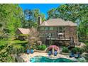 Beautiful backyard with a private pool, deck, landscaped yard, and lots of trees at 14131 Lea Point Ct, Huntersville, NC 28078