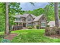 Charming home with stone and brick exterior and landscaped yard on a cloudy day at 14131 Lea Point Ct, Huntersville, NC 28078