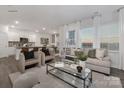 Spacious living room with hardwood floors, large windows, and open concept kitchen at 1419 5Th Street Ne Dr, Hickory, NC 28601