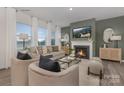 Cozy living room features a fireplace, large windows, and stylish furniture at 1419 5Th Street Ne Dr, Hickory, NC 28601