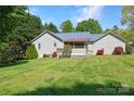 Expansive backyard featuring lush green lawn and the rear of the house with a screened porch at 1537 Haupt Strasse None, Conover, NC 28613