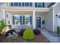 Welcoming front porch features decorative plants and comfortable rocking chairs at 1543 Ab Moore Jr Dr, Indian Trail, NC 28079
