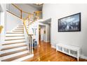 Bright foyer with a grand staircase, hardwood floors, and elegant decor at 16532 Flintrock Falls Ln, Charlotte, NC 28278