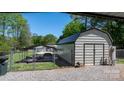 Durable metal shed and boat under carport with a fenced yard at 2003 Cape Hickory Cutoff Rd, Hickory, NC 28601