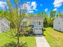 Charming two-story home with gray siding, a black roof, and manicured landscaping on a beautiful sunny day at 2115 Sonoma Valley Dr, Charlotte, NC 28214