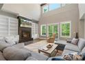 Bright, open living room with a cozy fireplace, large windows, and comfortable seating at 220 Palm Cove Way, York, SC 29745