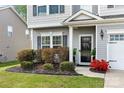 Inviting front entrance featuring a manicured lawn, dark shutters, and a well-maintained exterior at 2262 Galloway Sw Ln, Concord, NC 28025
