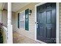 Inviting front entrance with dark door, green shutters, and a classic lantern-style light fixture at 2290 Kestrel Dr, Rock Hill, SC 29732