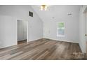 Spacious living room with vaulted ceiling, light-toned wood floors, and white walls for a modern feel at 2290 Kestrel Dr, Rock Hill, SC 29732