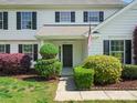 Close-up of the home's entrance, showcasing a black front door and well-maintained landscaping at 3002 Fair Meadows Dr, Monroe, NC 28110