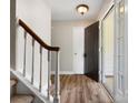 Hallway view with hardwood floors and stairs, leading to the upper level of the home at 3002 Fair Meadows Dr, Monroe, NC 28110