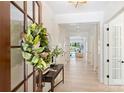 Bright foyer featuring hardwood floors, white walls, and an elegant, lengthy hallway at 3473 Willow Oak Rd, Charlotte, NC 28209