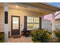 Inviting front porch with a seating area, decorative shrubs, and a view of the charming neighborhood at 3637 Allenby Pl, Monroe, NC 28110