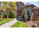 Stunning brick and stone home with a beautifully landscaped entrance and decorative front door at 364 Stone Cliff Ln, Clover, SC 29710