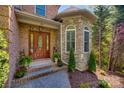 Inviting front entrance with brick and stone accents, a decorative door, and well-manicured landscaping at 364 Stone Cliff Ln, Clover, SC 29710