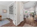 Elegant hallway featuring hardwood floors, a built-in bookcase, and an open view to the living spaces at 4012 Moxie Way, Charlotte, NC 28215