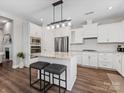 Modern kitchen with white cabinetry, granite countertops, and stainless steel appliances at 4012 Moxie Way, Charlotte, NC 28215
