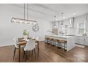 Open concept kitchen and dining area with an island and modern pendant lighting at 4019 Plaza Row Ct, Charlotte, NC 28205