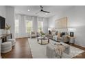 Bright living room featuring hardwood floors, large windows, and neutral tones at 4019 Plaza Row Ct, Charlotte, NC 28205