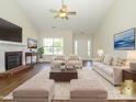 Staged living room with a fireplace, neutral furniture, and a large area rug at 4203 Ethel Sustar Dr, Monroe, NC 28110