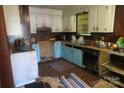 Dated kitchen featuring blue-painted cabinets and a worn floor, ready for renovation at 4814 Chapel Grove Rd, Gastonia, NC 28052