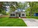 Inviting home with lush green lawn, mature trees, and a cozy facade with black shutters at 508 Clegg St, Shelby, NC 28150