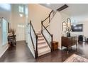 Inviting foyer showcasing hardwood floors, staircase with white railings, and natural light at 5150 Mount Clare Ln, Charlotte, NC 28210