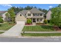 An elevated shot of a 2 story home, green lawn, attractive landscaping, and a 2 car garage at 541 Nw Sutro Forest Dr, Concord, NC 28027