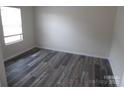 Bright bedroom featuring clean white walls, a new window, and stylish flooring at 574 30Th Avenue Ne Cir, Hickory, NC 28601