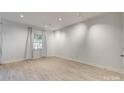 Bright room with neutral walls, track lighting, and wood-look flooring at 5901 Quail Hollow Rd # G, Charlotte, NC 28210