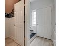 Bright entryway with wood floors, white doors, and stairs at 5901 Quail Hollow Rd # G, Charlotte, NC 28210