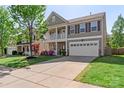 Attractive two-story home features a covered porch, stone detailing, and a spacious driveway for convenience at 6153 Kilchurn Dr, Fort Mill, SC 29707