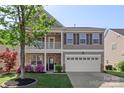 Well-maintained two-story home with a covered porch, stone accents, and a two-car garage offers classic charm at 6153 Kilchurn Dr, Fort Mill, SC 29707