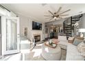 Bright living room with fireplace and stairs at 637 Williamson Rd # 309, Mooresville, NC 28117