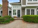 Close-up of front door with beautiful landscaping and well-maintained walkway at 8251 Tradd Ct, Charlotte, NC 28210
