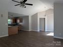 Open floor plan featuring updated flooring and bright lighting connects living and kitchen spaces at 8332 Highlander Ct, Charlotte, NC 28269