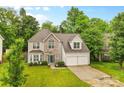 Charming two-story home featuring a stone facade, well-manicured lawn, and two-car garage at 9010 Davis Crossing Ct, Charlotte, NC 28269