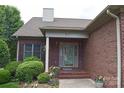 Brick front entrance with an ornate glass door and lovely landscaping at 904 3Rd Street Ne Pl, Conover, NC 28613