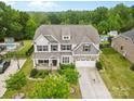 Sprawling two story home showcasing a pool, landscaped yard, and neutral color palette at 9303 Raven Top Dr, Mint Hill, NC 28227