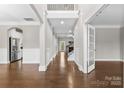 Elegant foyer with hardwood floors, wainscoting, and an open view to the staircase and living areas at 9303 Raven Top Dr, Mint Hill, NC 28227