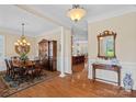 Elegant dining room boasts hardwood floors, decorative lighting, and classic furnishings, great for entertaining at 9803 Tree Canopy Rd, Charlotte, NC 28277
