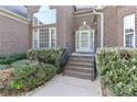 Inviting brick entrance with small brick steps, trimmed bushes and manicured landscape at 115 Players Park Cir, Statesville, NC 28677